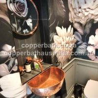 Half moon hammered copper basin compact for the tight space